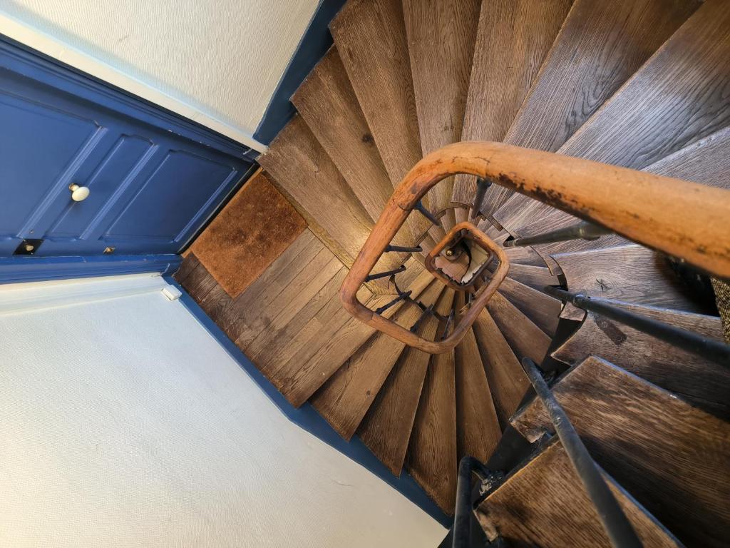 an overhead view of a wooden spiral staircase at B Appartement in Malakoff