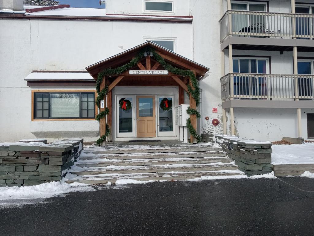 a front door of a house with wreaths on it at Ski to your back door! Shared condo with ski professional and cat. in Warren