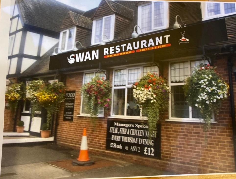 a small restaurant with a sign in front of it at swan hotel resturant bar and grill in Wellington