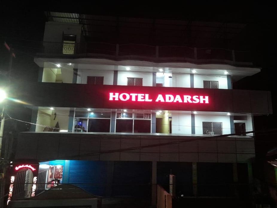 a hotelihad sign on a building at night at Adarsh Hotel in Port Blair