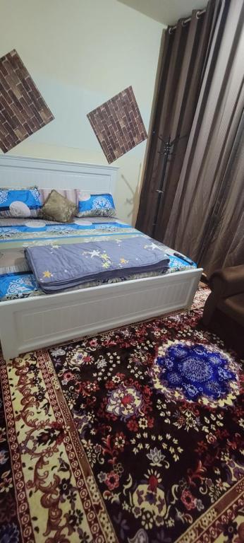 um quarto com uma cama e um tapete em MAMA DELIGHT GUEST ROOM em Abu Dhabi