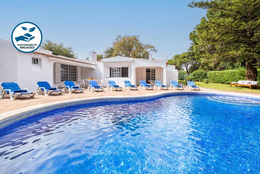a villa with a swimming pool in front of a house at Villa AlGharif by Algarve Vacation in Albufeira