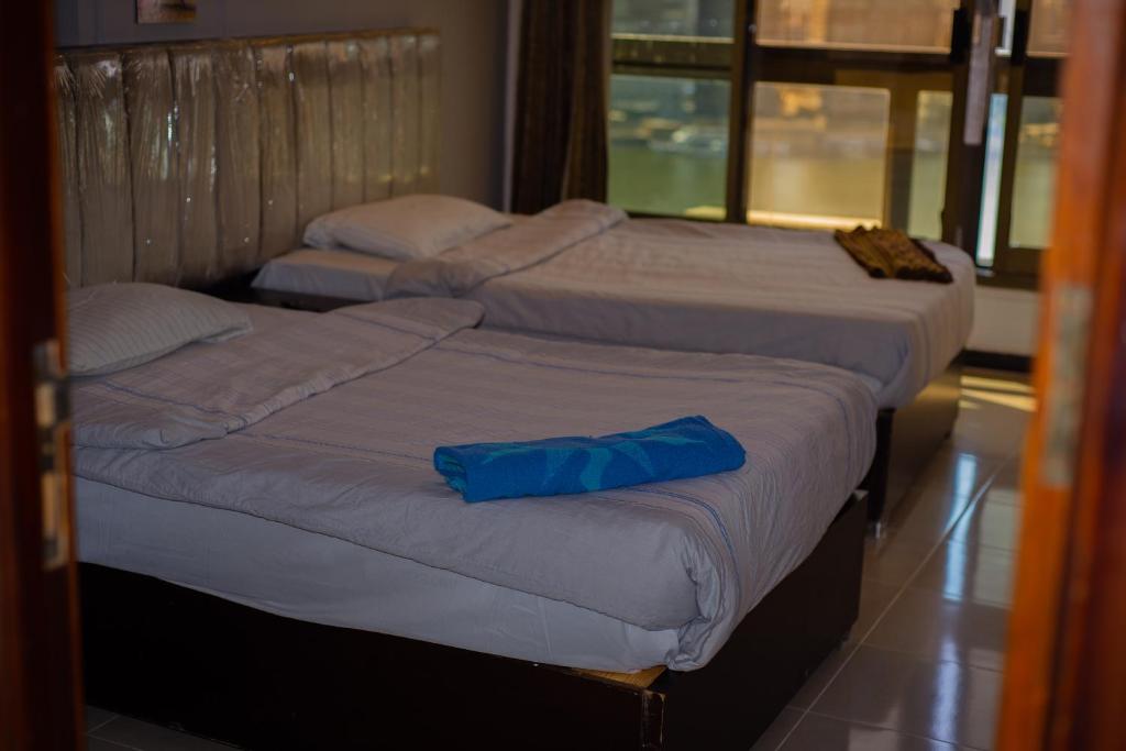 Postel nebo postele na pokoji v ubytování Jasmine Nile Sky Hotel