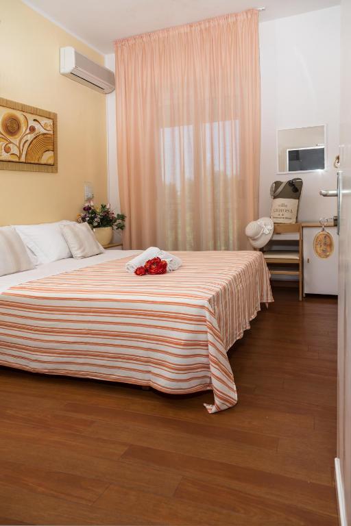 Postel nebo postele na pokoji v ubytování Hotel Villa Gioiosa
