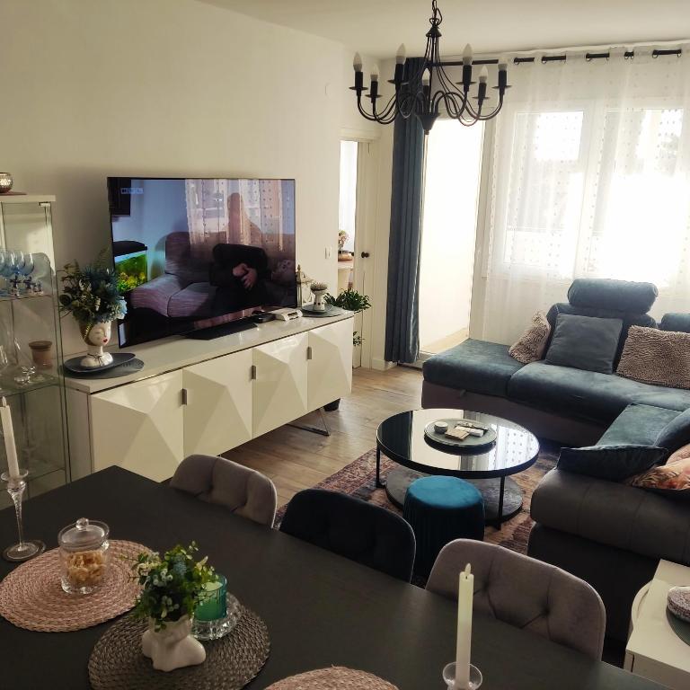 a living room with a couch and a flat screen tv at Lovely home M&R in Split