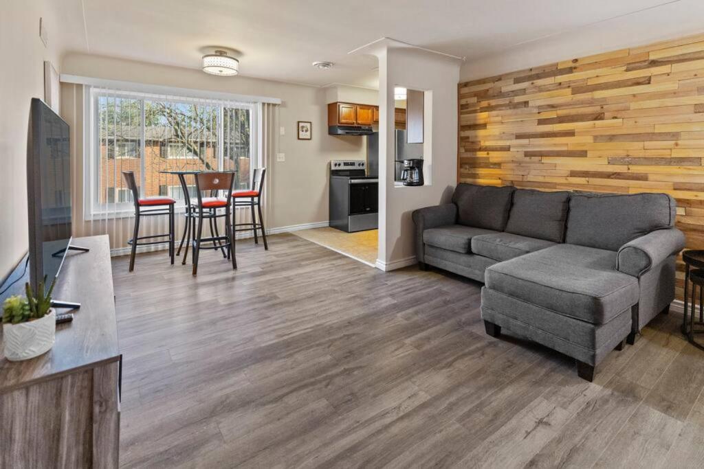 a living room with a couch and a table at Modern Cozy 2b apt in Shelby Twp in Shelby