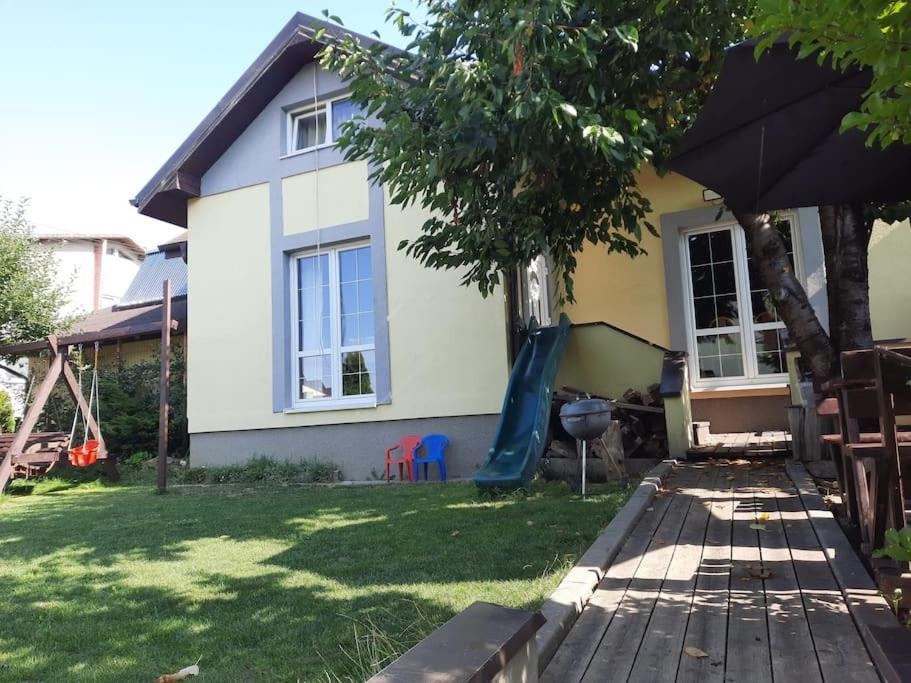a house with a blue slide in the yard at Domček v Tatrách in Poprad