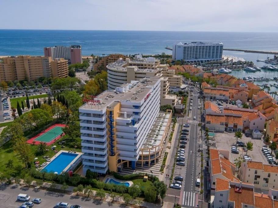 eine Luftansicht einer Stadt mit Gebäuden und dem Meer in der Unterkunft Newly refurbished 2 bed appt Vilamoura in Vilamoura