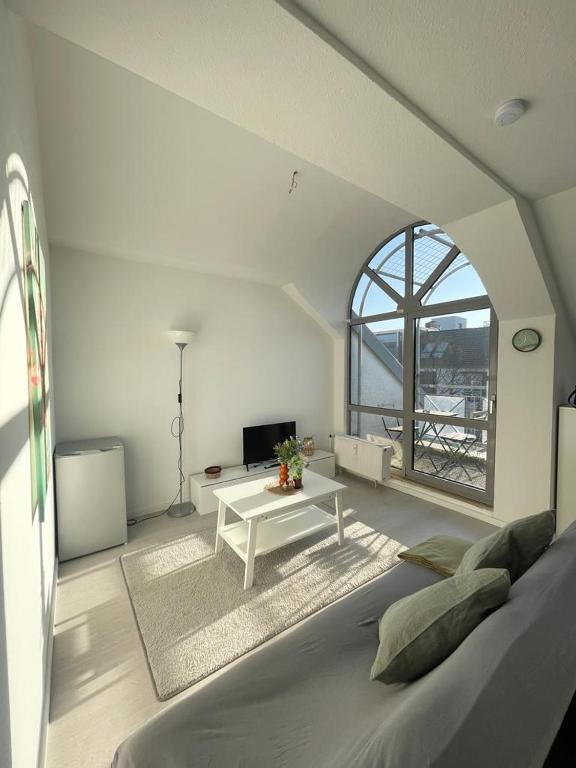 a large white room with a bed and a table at Premium Apartment 3 in Dillingen an der Saar