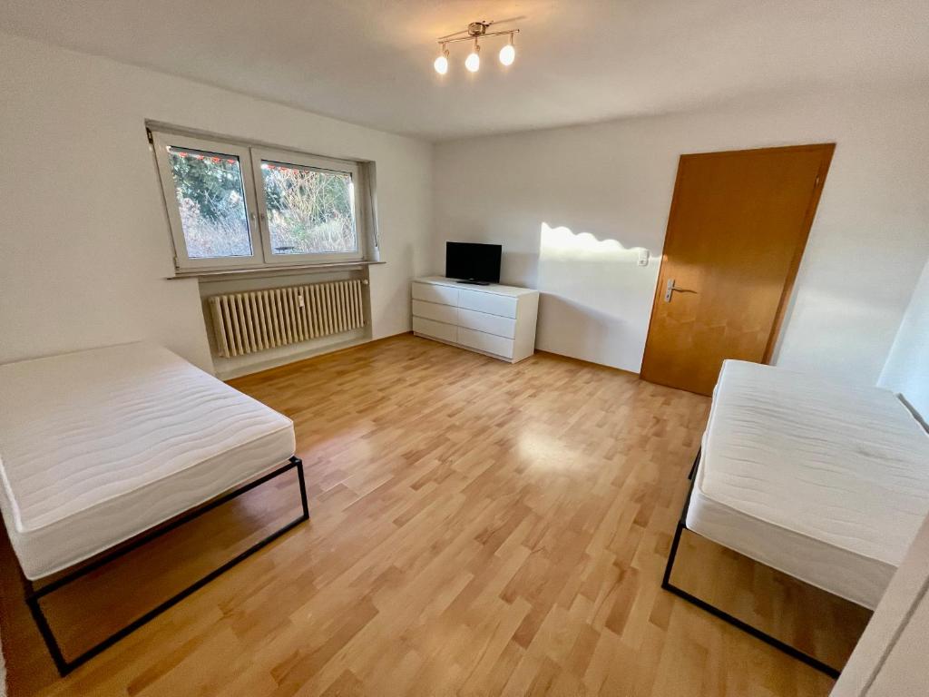 an empty room with two beds and a desk at Appartement Luna in Schweinfurt