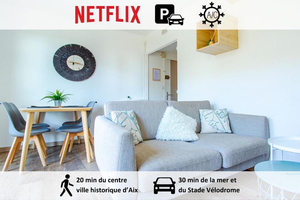 a living room with a couch and a table at T3 Calme Balcon Climatisation et Parking gratuit - Netflix - Stade Vélodrome in Aix-en-Provence
