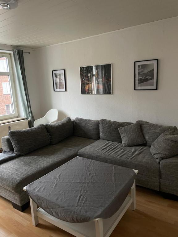 a living room with a couch and a table at Fewo Itzehoe in Itzehoe