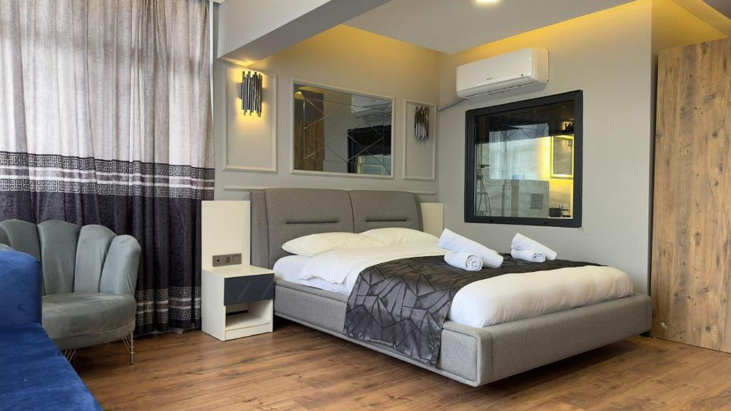 a bedroom with a bed and a chair in it at Wonne Boutique Hotel Spa in Ankara