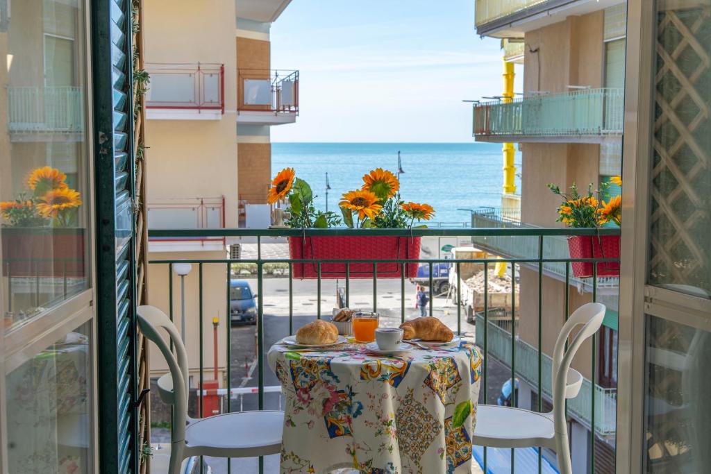 a balcony with a table and a view of the ocean at La Casa di Aurora in Maiori