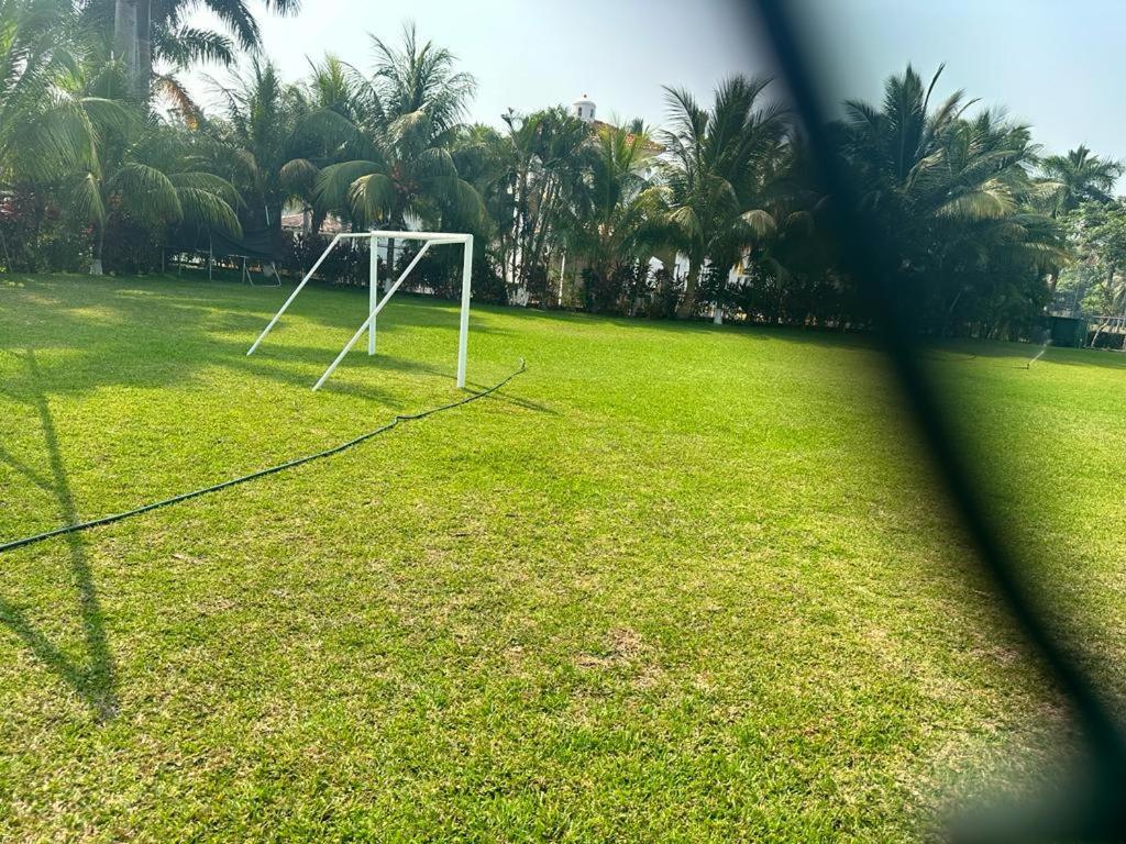 a soccer goal in a field with palm trees at alquiler puerto de San Jose in San José de Guatemala