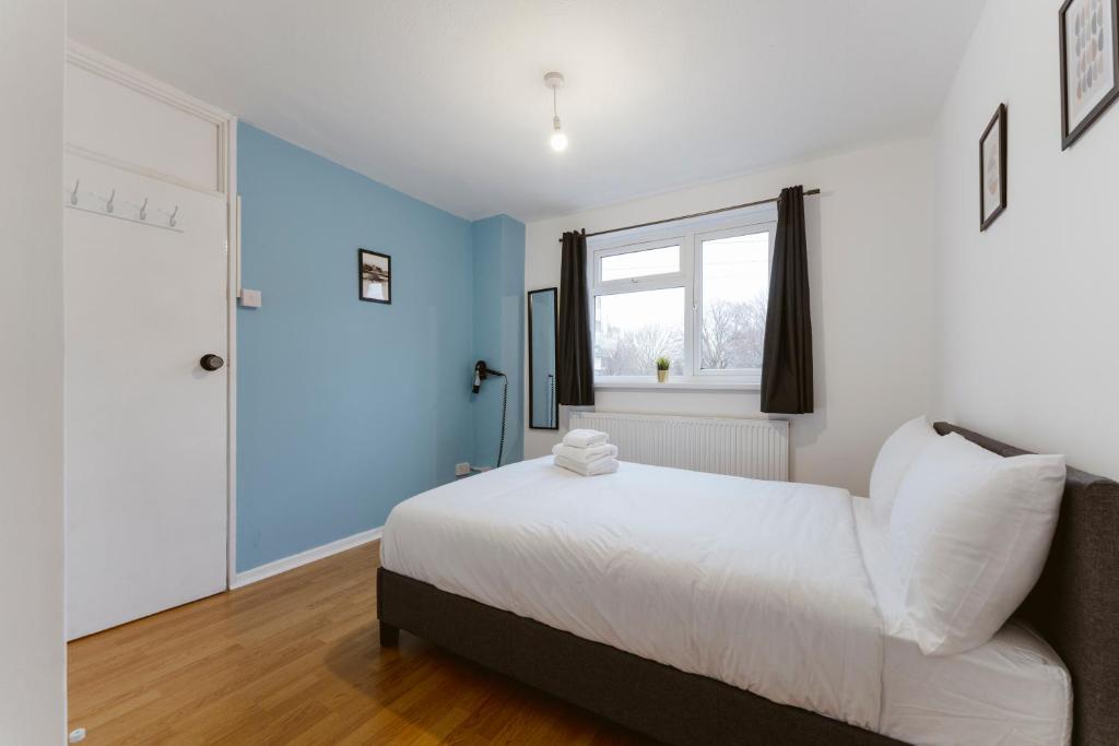 a bedroom with a white bed and a window at Stratford Great Rooms to stay - 20 in London