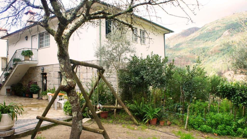 a tree in front of a house at Casa da Igreja by Gerês Casas in Geres