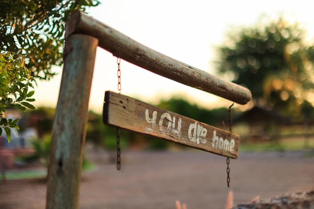 a sign that says walk up hope hanging from a pole at SABI Escapes in Mochudi
