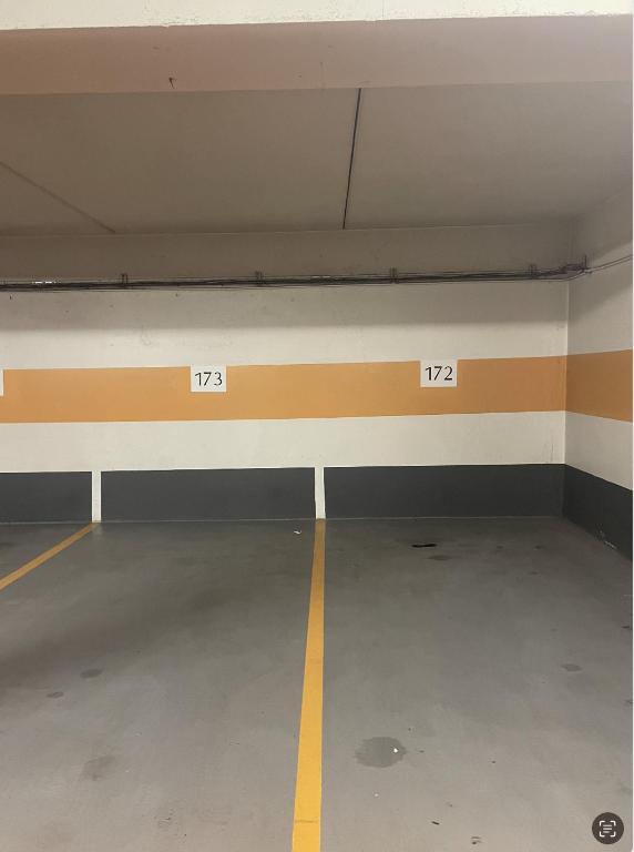 an empty parking garage with two numbers on the wall at Appartement T3 ARC 1950 skis aux pieds Sauna, Hammam, Jacuzzi in Arc 1950