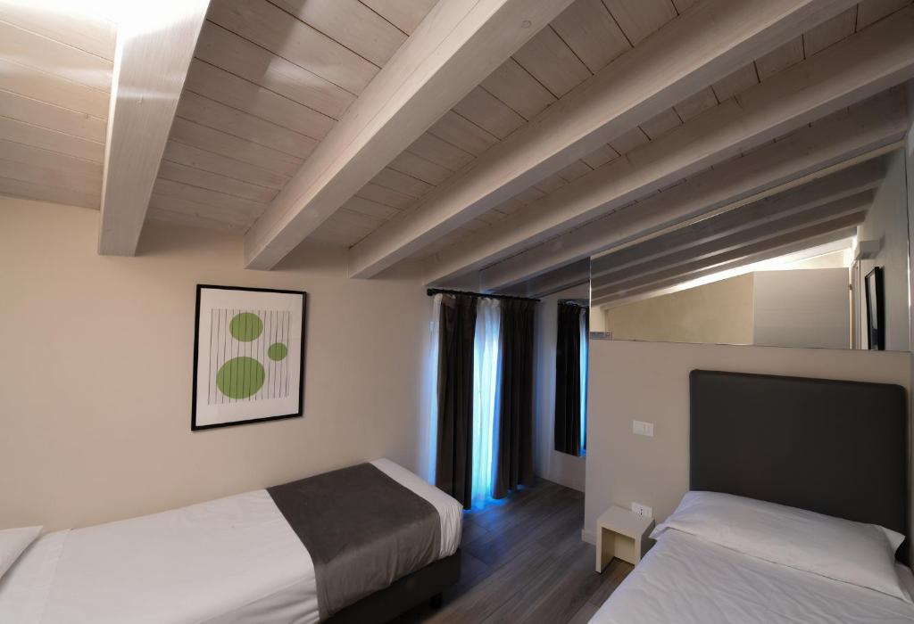 Postel nebo postele na pokoji v ubytování HILL COLLE - camere & bistrot