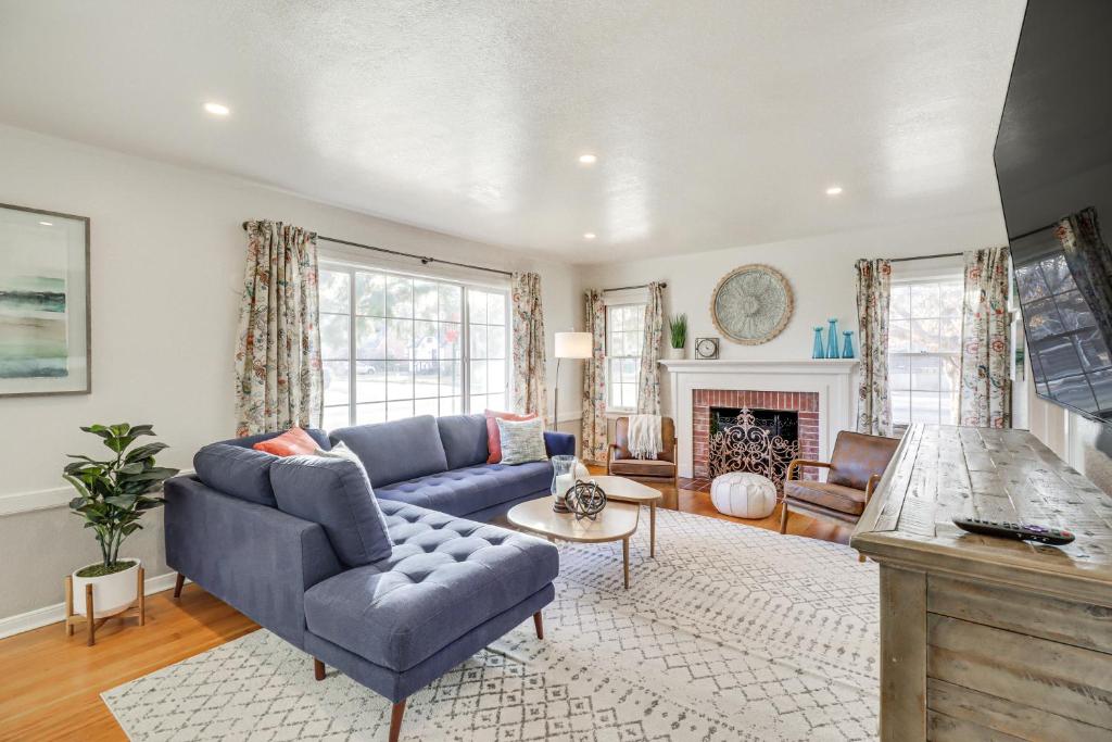 a living room with a blue couch and a fireplace at Centrally Located Reno House Less Than 1 Mi to Midtown in Reno