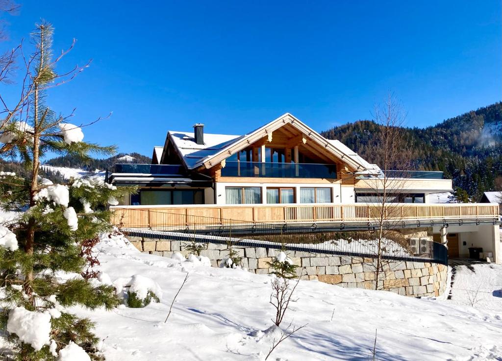 a house on a hill with snow on the ground at Alpen Luxury Lodge, MARIAZELL in Mariazell