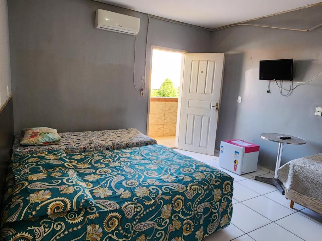 a bedroom with a bed and a door with a window at Condomínio Center luz in Teresina