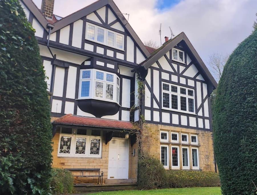 a black and white house with a porch at Spacious Guest Flat near Roundhay Park in Roundhay