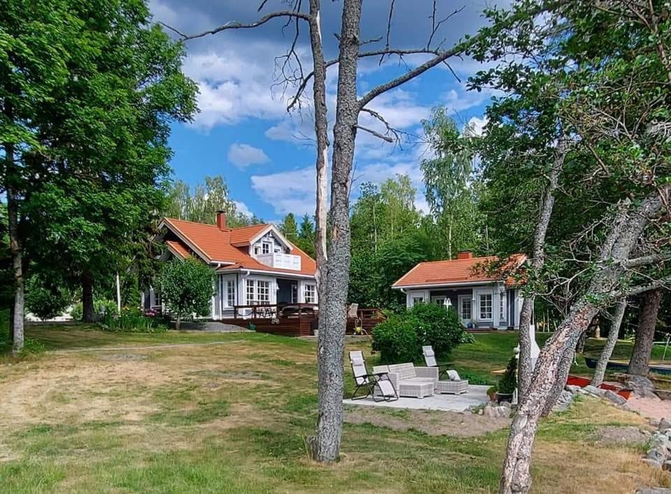 a large white house with a red roof at Villa Onnela Ämttöö in Pori