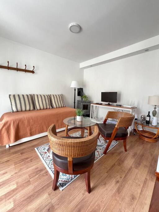 a living room with a bed and a table and chairs at Casa moderna recien terminada in Maldonado