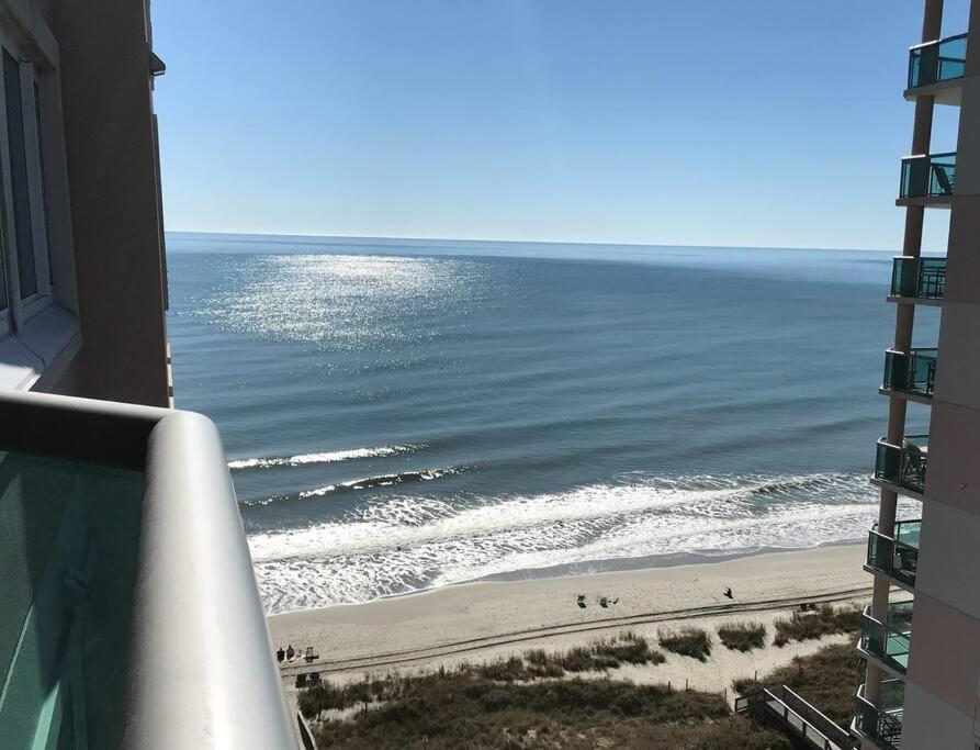 a view of the beach from the balcony of a building at Oceanfront Get Away in Myrtle Beach