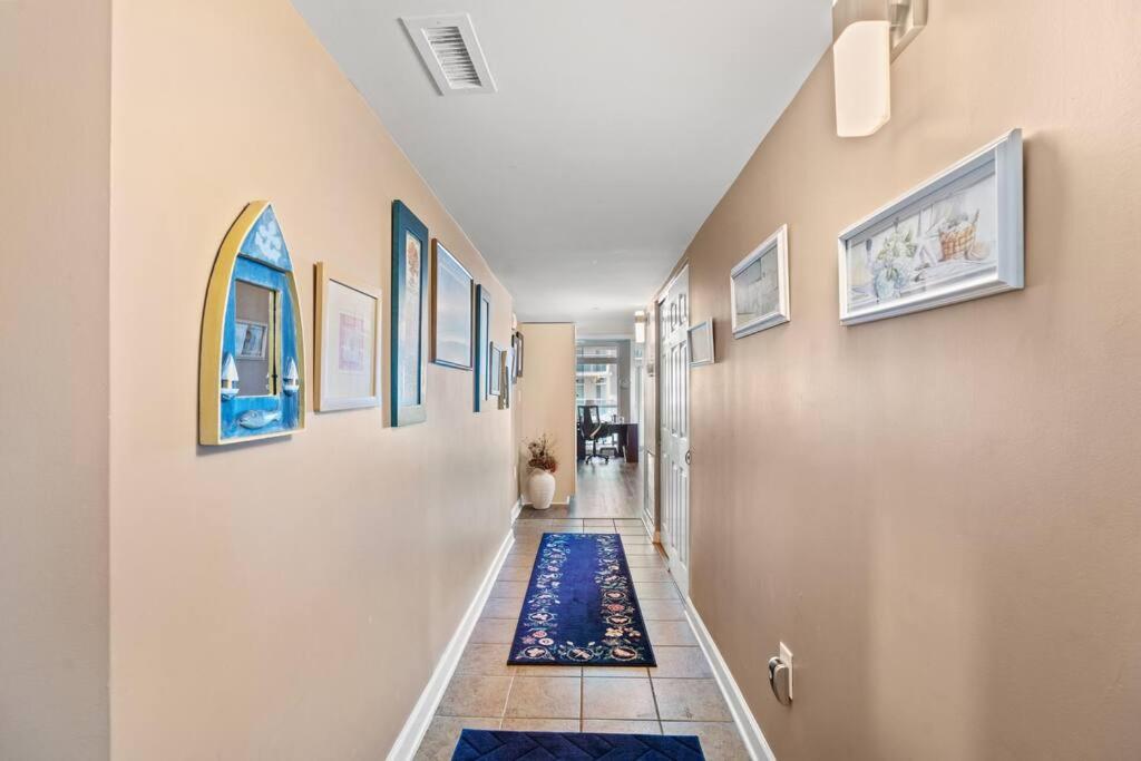 a hallway with a blue rug on the floor at Oceanfront Get Away in Myrtle Beach