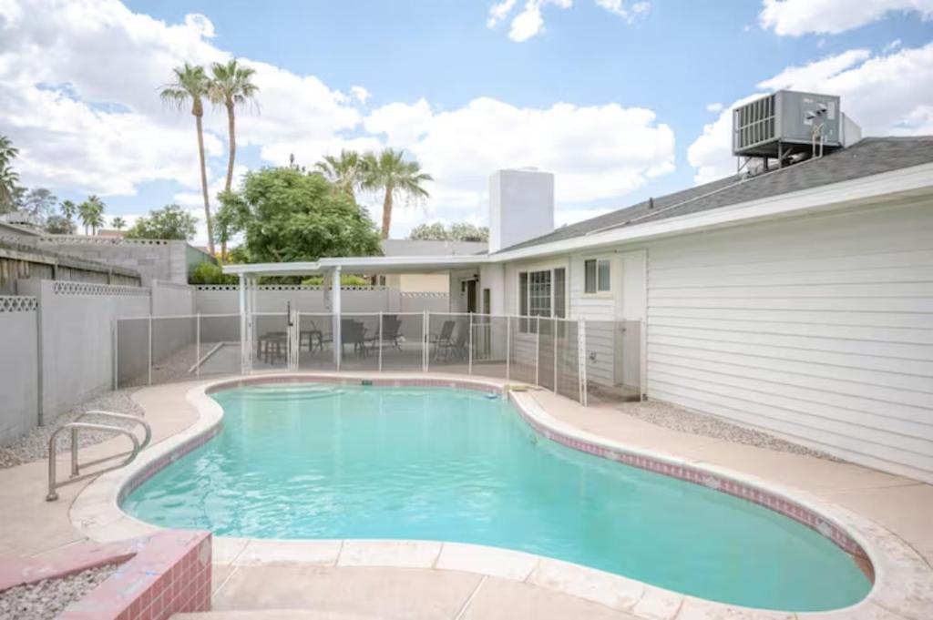 a swimming pool in front of a house at Pool 4 bedroom 2 bath close to Strip in Las Vegas