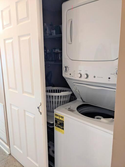 a washer and dryer sitting on top of a washing machine at Oceanfront Get Away in Myrtle Beach