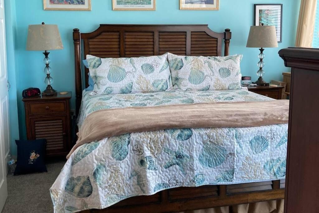 a bedroom with a large bed with blue walls at Oceanfront Get Away in Myrtle Beach