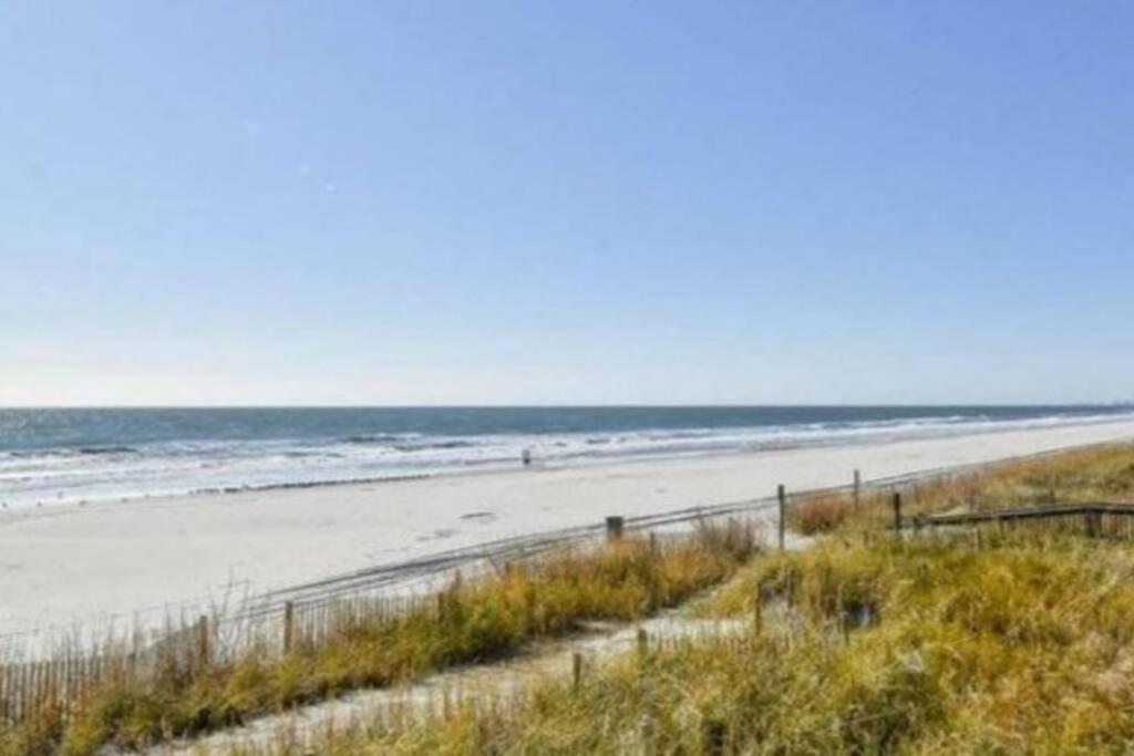 a beach with the ocean in the background at Oceanfront Get Away in Myrtle Beach