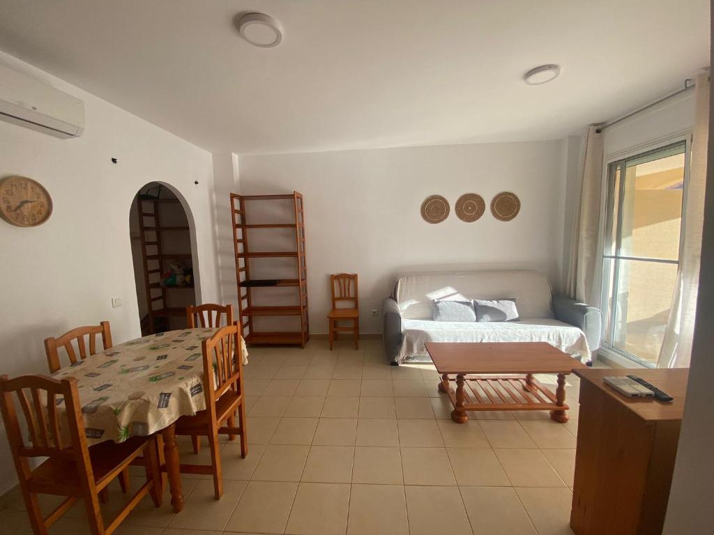 a living room with a bed and a table and chairs at Eco tourist in Riumar