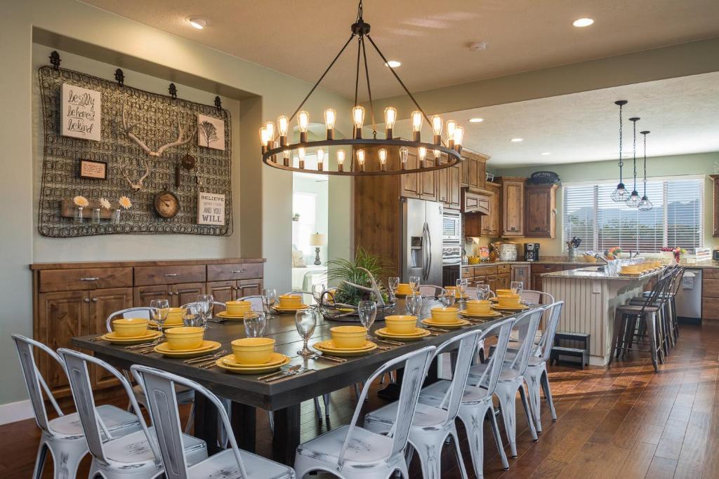 a large dining room table with yellow dishes on it at 3| Grand View Estate in St George with Views and Lawn in Santa Clara