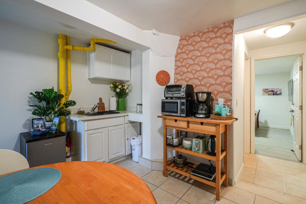 a kitchen with a table and a microwave on a counter at San Francisco Apartment about 5 Mi to Downtown! in San Francisco