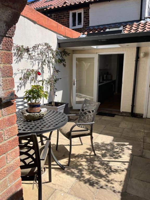 a patio with a table and chairs on a patio at Arden on Albert in Beverley