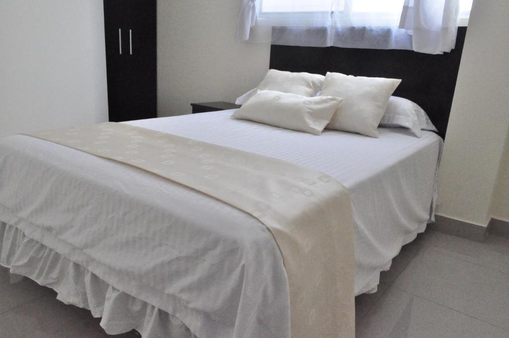 Postel nebo postele na pokoji v ubytování Valdivia Suites