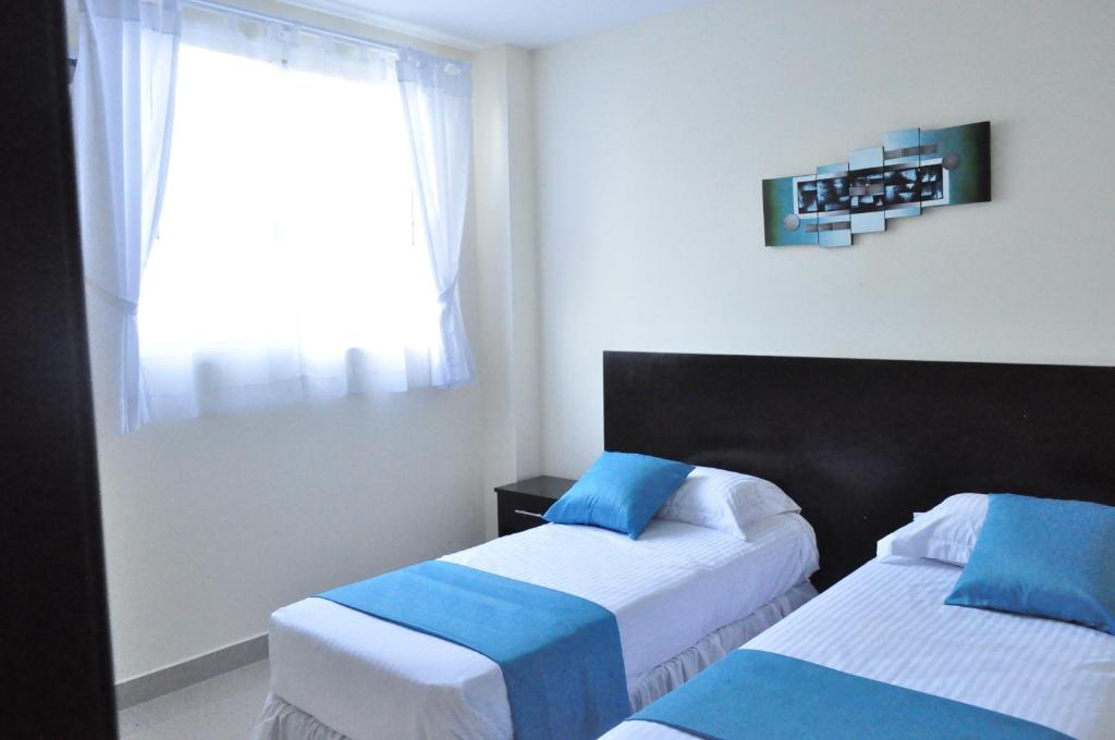 Postel nebo postele na pokoji v ubytování Valdivia Suites