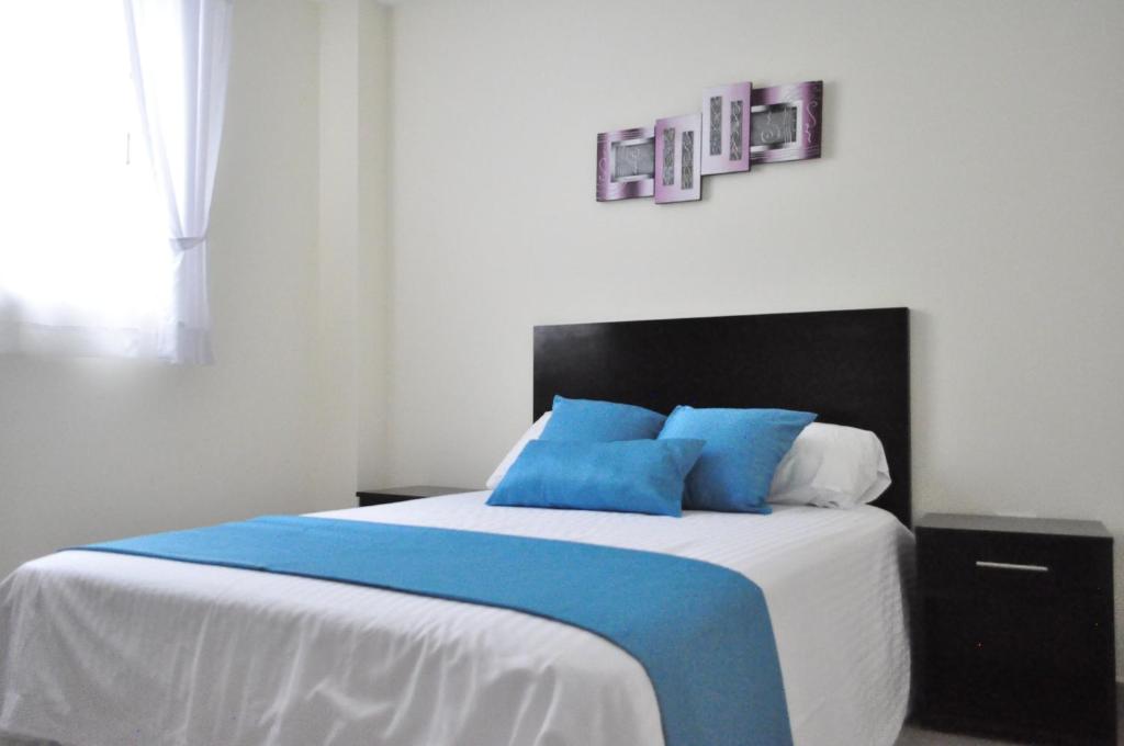 Postel nebo postele na pokoji v ubytování Valdivia Suites