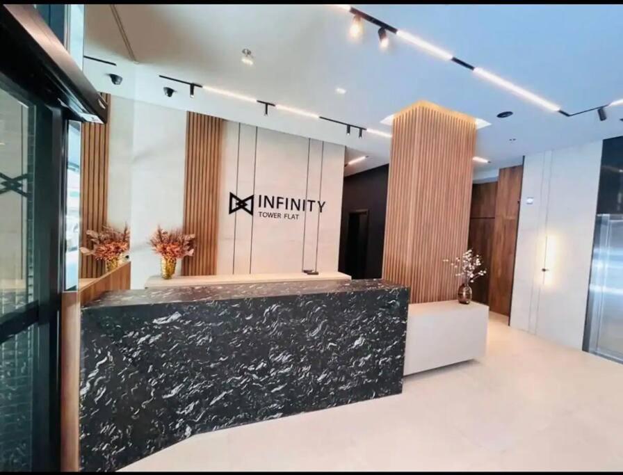 a lobby of an office building with a black counter at Infinity Tower Flat - 1403 in Itapema