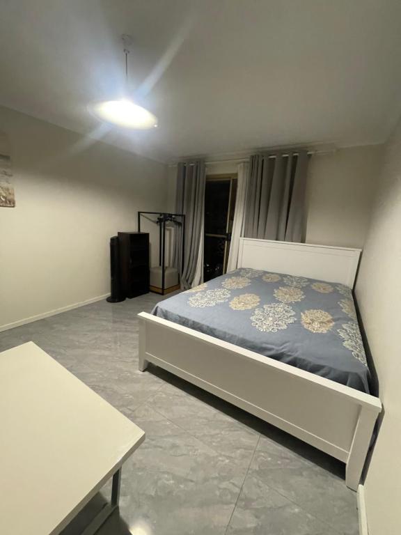 a bedroom with a bed and a table at Easy Way Scarborough in Perth