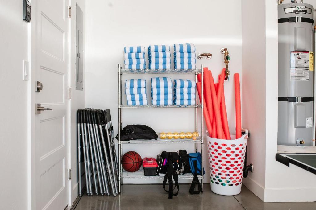 a shelf with umbrellas and other items in a room at 20| Vue at Green Valley with Community Pool in St. George
