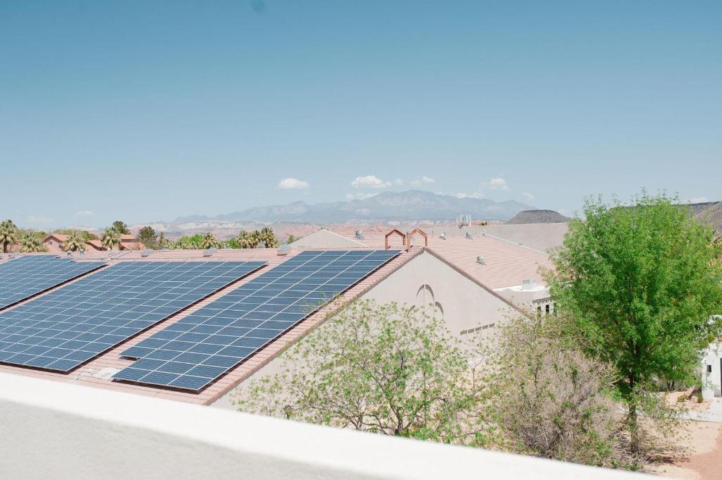a group of solar panels on top of a roof at 20| Vue at Green Valley with Community Pool in St. George