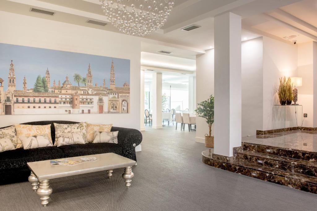 a living room with a couch and a table at Hotel Infanta Leonor in Écija