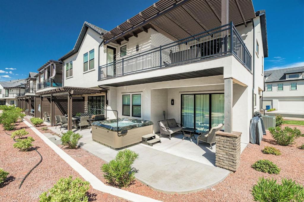 a house with a swimming pool and a balcony at 13| Red Mountain View in St. George with Private Hot Tub in Santa Clara