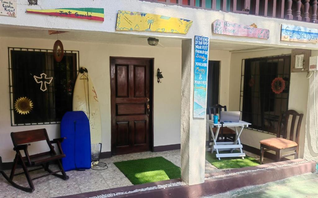 a house with a door and a table and chairs at Casa Condo Playa Samara in Sámara